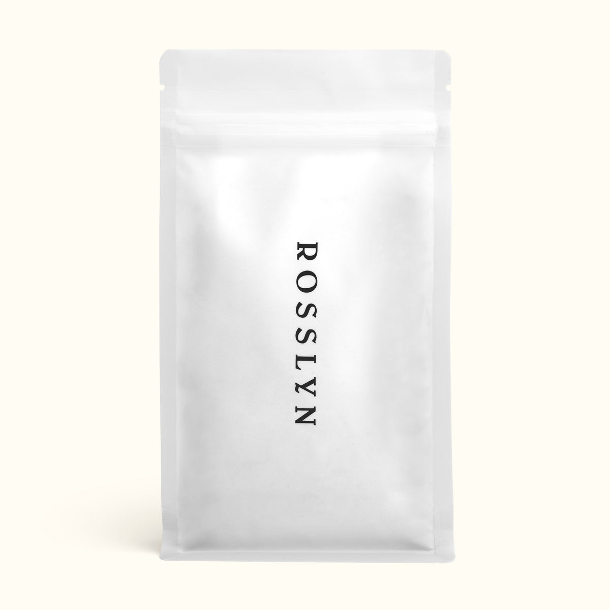 A sealed white bag of Rosslyn branded coffee beans.